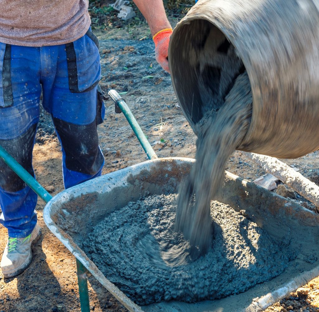 builder-pouring-cement-from-a-cement-mixer-2023-11-27-05-27-33-utc